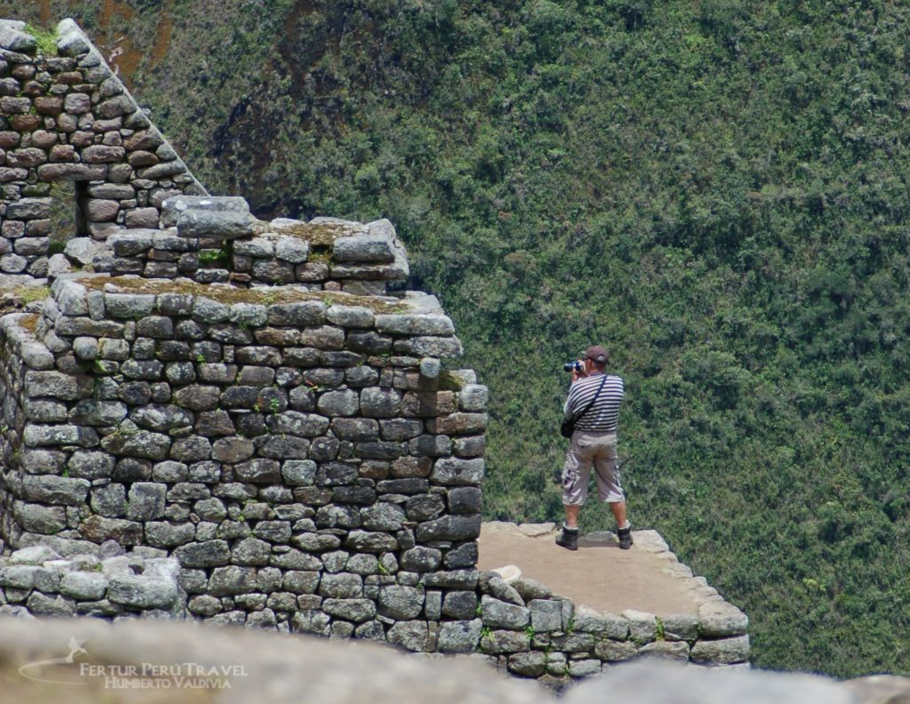 Photographer stakes out a corner of Machu Picchu on Circuit 3 for shots of the lower terraces and Huayna Picchu. 